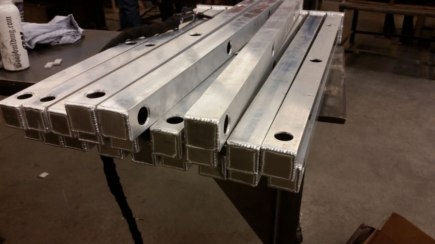Welded aluminium box-section members with machined and bored mounting holes